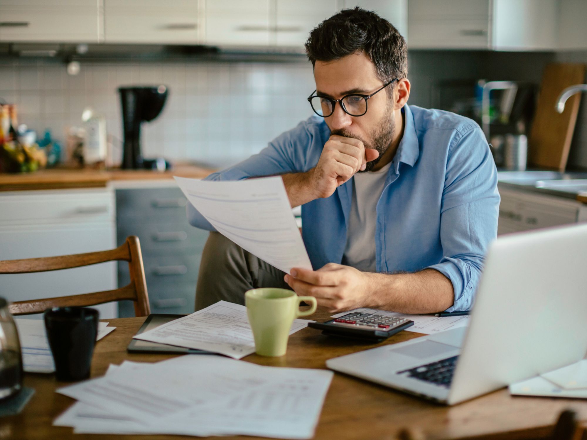 Man looking over bills figuring out how to get help