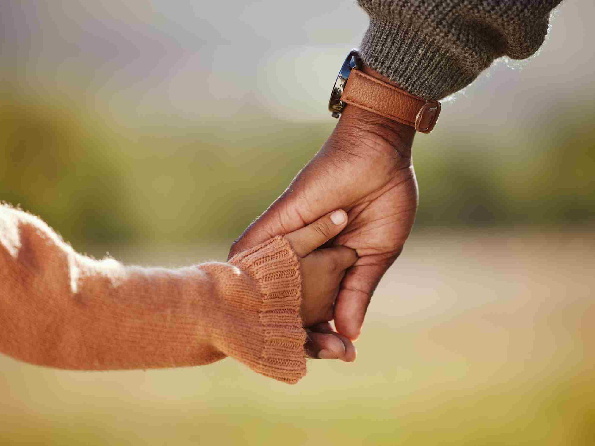 Child holding adult hand