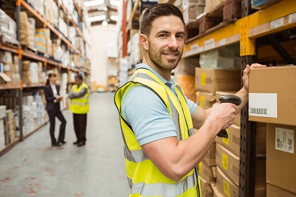 Hardware store employee stamping boxes