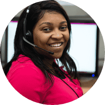 Woman working with a headset on looking at camera