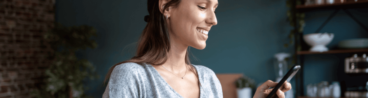 Woman looking at phone and smiling