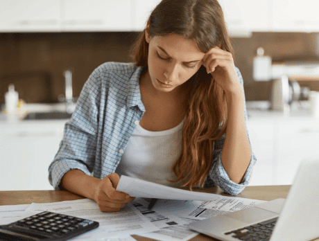 A stressed woman looking at bills