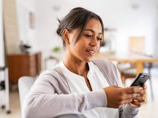 Niña afroamericana enviando mensajes de texto
