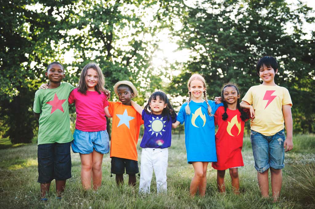 diverse kids standing in grass