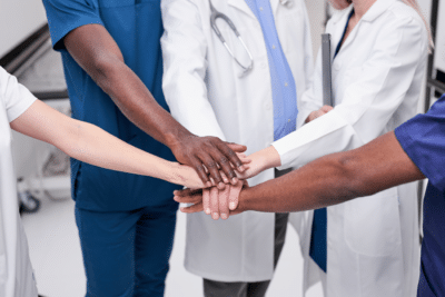 doctor hands together for care coordination