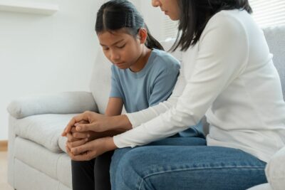 Mom comforting daughter struggling with metnal health