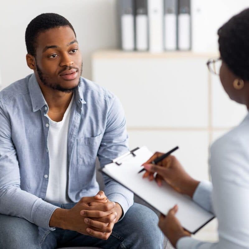 Black man talking to a mental health counselor