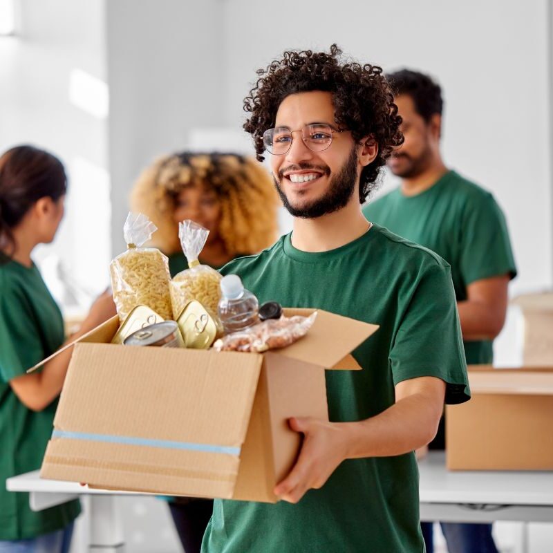 Man handing out box of food