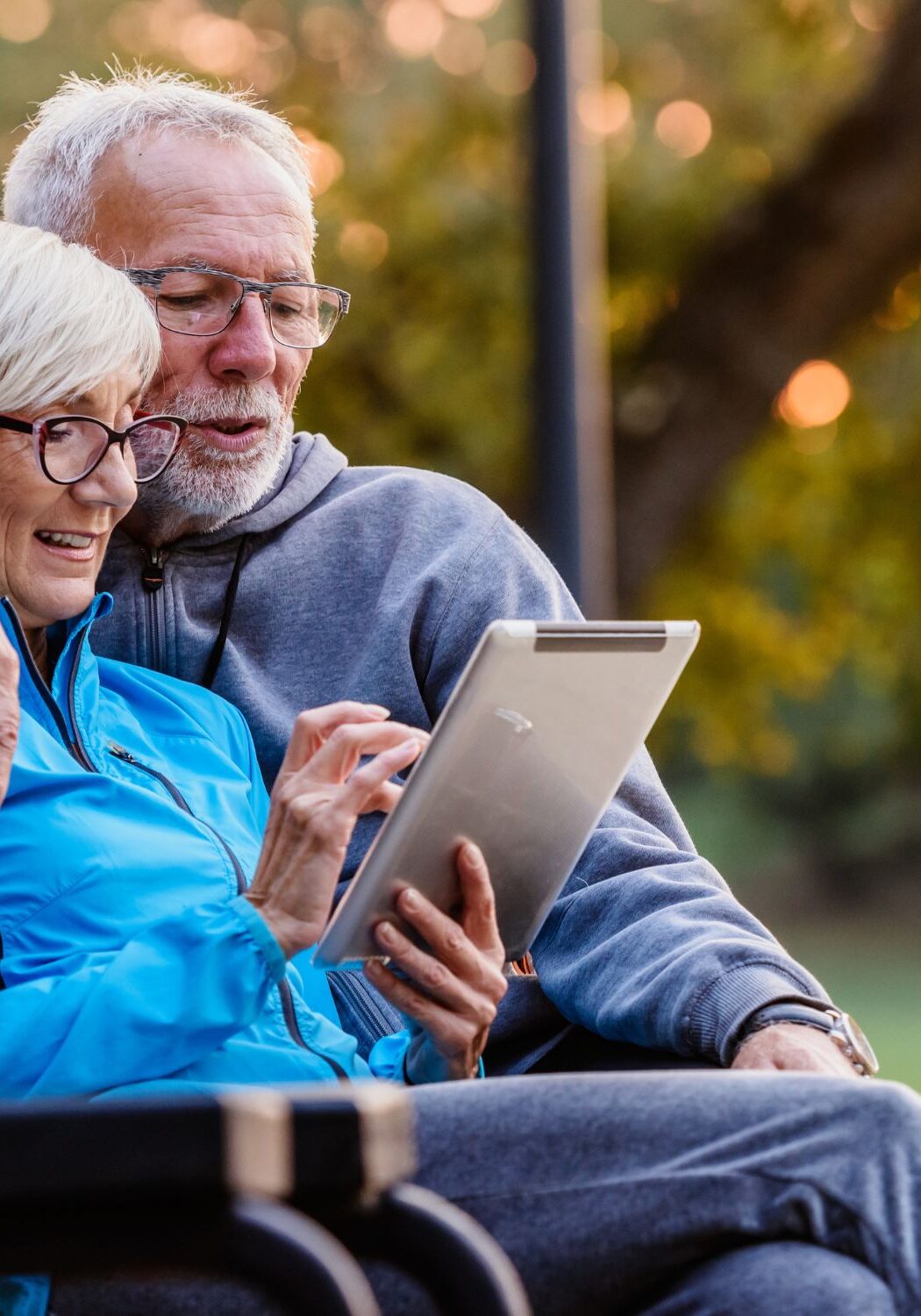 Senior couple looking at Medicare options on tablet