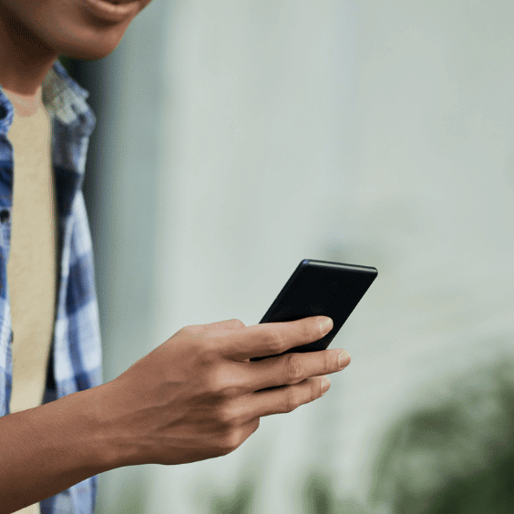 Teen walking and looking at phone