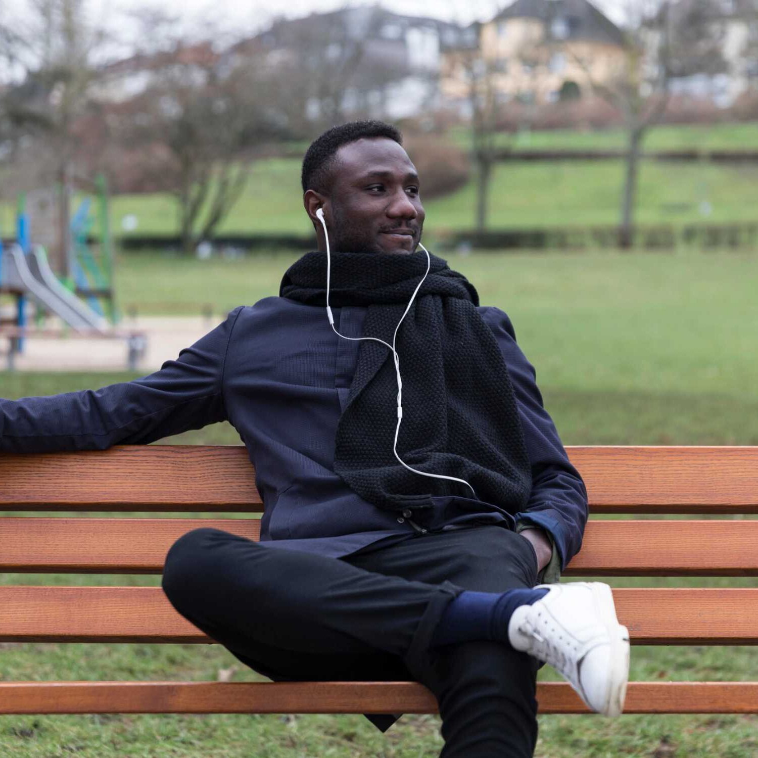 Thoughtful man sitting on park bench