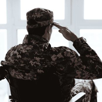 Veteran in a wheelchair saluting