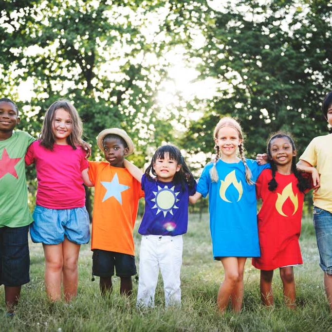 diverse kids standing in grass