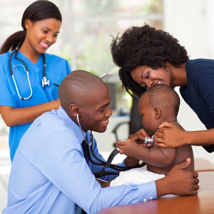 doctor with young child providing health care
