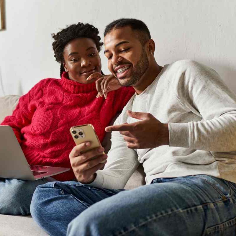 couple pointing to phone