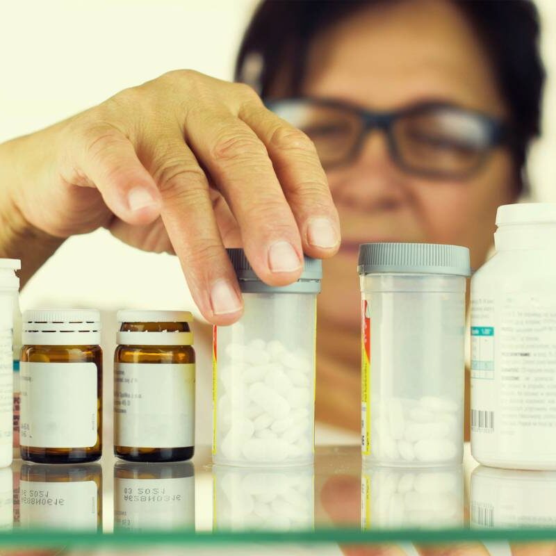 going through medicine cabinet looking at pills