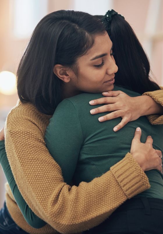 two friends hugging and offering support two friends hugging and offering support