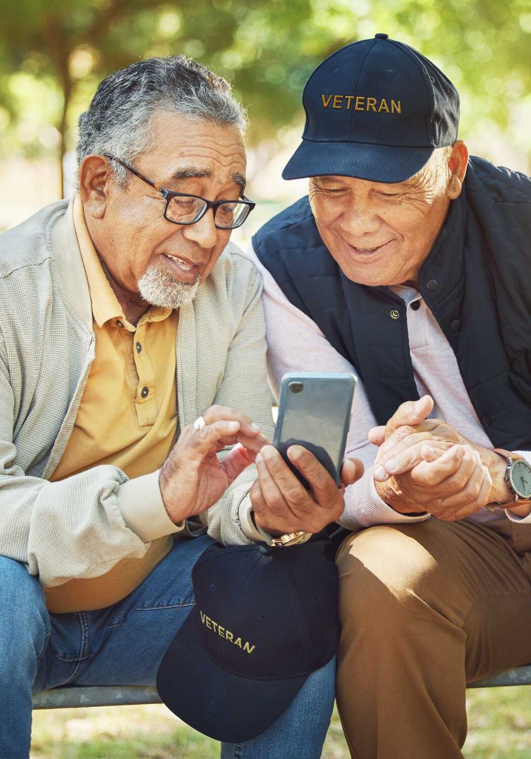two older veterans helping each other at park