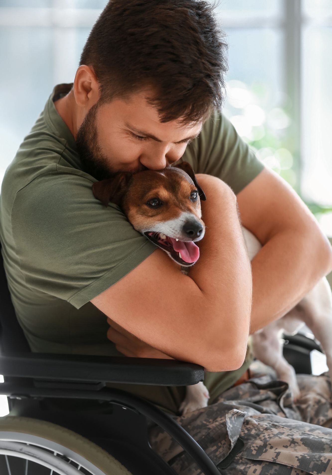 veteran hugging a dog